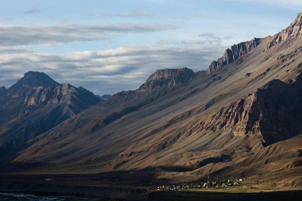 Dramatic view of the Spiti Valley with towering mountains in Himachal Pradesh, India.