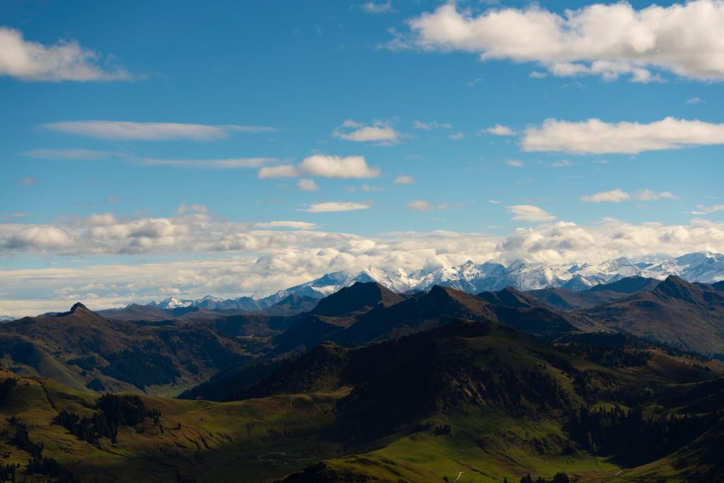 Majestic alpine mountains with snow peaks under a clear blue sky, perfect for travel inspiration.
