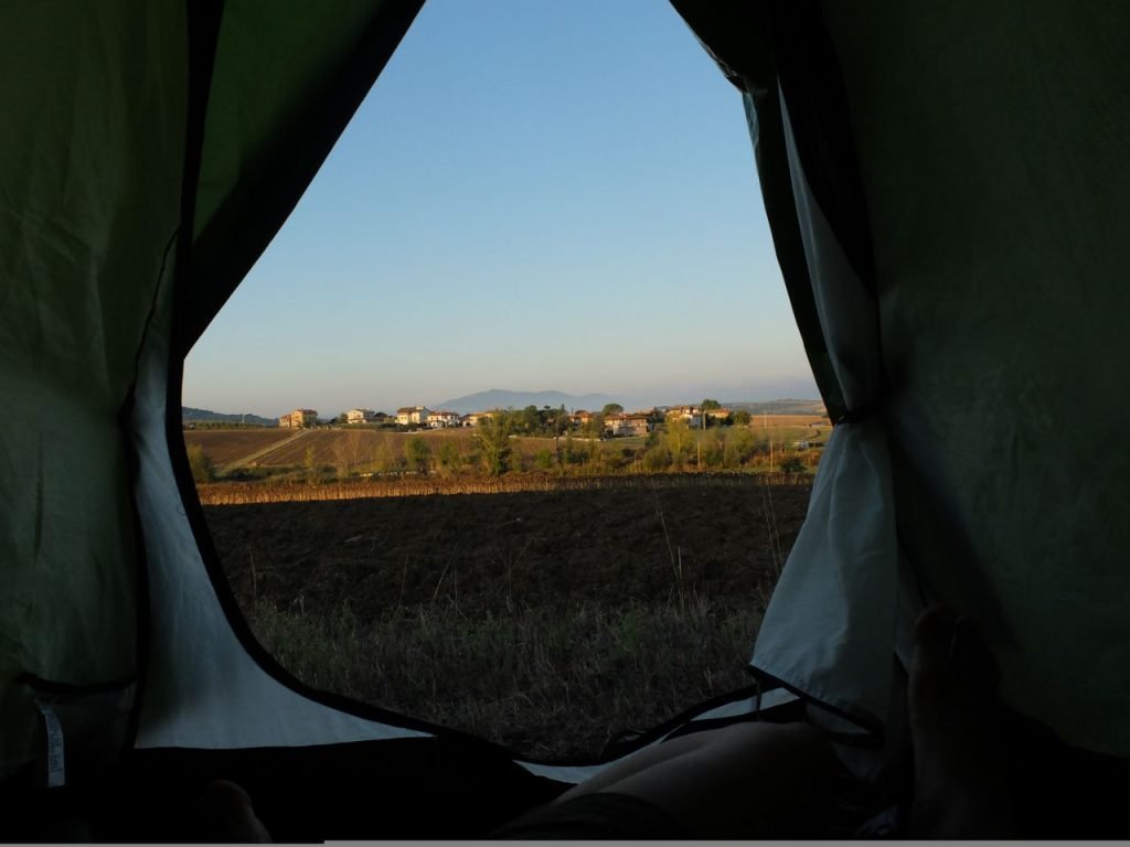 A beautiful early morning view of the countryside from inside a camping tent.